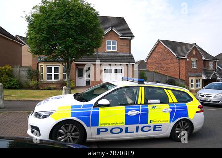 Une voiture de police renoue avec la maison de l'ancien premier ministre d'Écosse Nicola Sturgeon, à Uddingtson, Glasgow, après son arrestation dimanche dans le cadre de l'enquête policière sur les finances du SNP. L'arrestation de l'ancien premier ministre intervient après l'arrestation de son mari Peter Murrell en avril. Date de la photo: Lundi 12 juin 2023. Banque D'Images