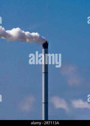 De la vapeur s'échappe dans l'atmosphère d'une cheminée de l'usine Greenatham Works de Venator Chemical. Vu contre un ciel bleu Banque D'Images