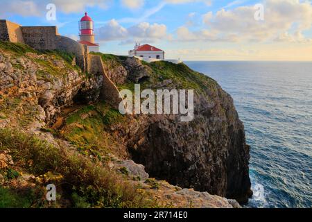 Un phare pittoresque de Cabo de Sao Vicente perché au sommet d'une falaise rocheuse surplombant l'océan pendant le coucher du soleil Banque D'Images