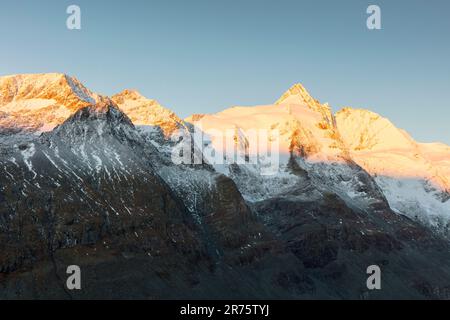 Großglockner avec groupe Glockner, sommet au lever du soleil, rouge du matin, neige, ciel bleu Banque D'Images