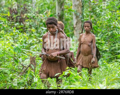 Les habitants du village de la tribu Korowai reviennent de la forêt. Tribu de Korowai (Kombai , Kolufo). Banque D'Images