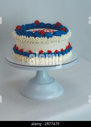 gâteau givré blanc bleu rouge isolé sur fond blanc de studio. Couleurs du drapeau américain. Célébration. Banque D'Images