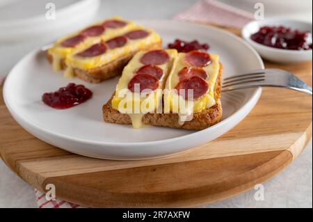 Sandwich au fromage grillé ouvert avec brie, salami espagnol. Servi avec de la sauce aux canneberges Banque D'Images