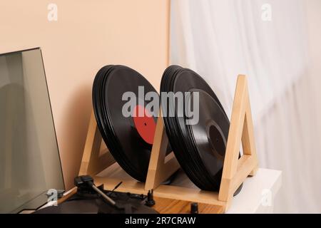 Disques en vinyle et lecteur sur table en bois blanc à l'intérieur Banque D'Images