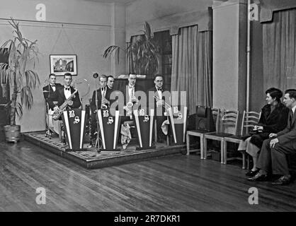 Un groupe de danse britannique de quatre pièces, le Brian Scammell Dance Band sur scène au Royaume-Uni en 1937. Les premiers groupes de danse et de swing ont eu leur âge d'or au Royaume-Uni durant la période 1920s-30s. Groupes joués dans les salles de danse et les salles de bal de l'hôtel. Ils jouaient de la musique mélodique et de bon temps et des joueurs individuels joueraient dans plusieurs groupes. Cette image provient d'un vieux négatif en verre – une photographie vintage de 1930s. Banque D'Images