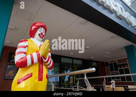 PATTAYA, THAÏLANDE - VERS AVRIL 2023 : la statue Ronald McDonald grandeur nature accueille les clients avec l'accueil thaï traditionnel au restaurant McDonald's. Banque D'Images