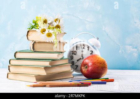 Livre avec des pages ouvertes en forme de coeur et des livres empilés sur le bureau de lecture dans la bibliothèque. Bibliothèque nationale, amateurs de livres jour ou mois. Retour à l'école ou Banque D'Images