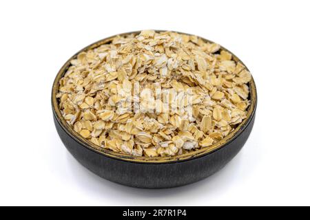 Flocons d'avoine ou flocons d'avoine isolés sur fond blanc. Flocons d'avoine dans le bol Banque D'Images
