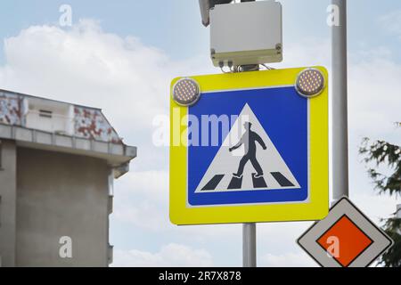 Panneau de signalisation passage piéton et route principale contre le ciel extérieur Banque D'Images