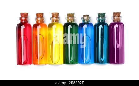 Flacons en verre avec différentes couleurs alimentaires sur fond blanc, vue de dessus Banque D'Images
