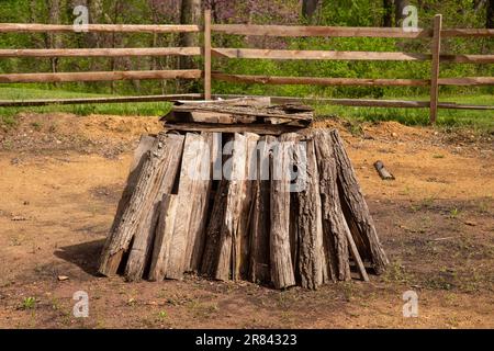 Le bois de chauffage en rondins fendus forme une pile circulaire pour un feu de joie Banque D'Images