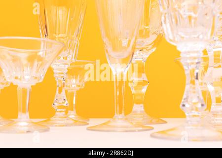 Gros plan des verres en cristal devant un fond jaune. Placer pour le texte. Banque D'Images