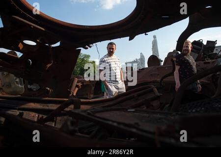 Kiev, Ukraine. 18th juin 2023. Les résidents de Kiev inspectent l'intérieur d'un véhicule blindé russe détruit lors d'une exposition d'armes et d'équipements russes sur la place Mykhailivska à Kiev. Le matériel militaire russe récupéré a été exposé pour que les résidents de Kiev viennent observer sur la place Mykhailivska à Kiev, en Ukraine. Le matériel militaire a été recueilli dans divers champs de bataille en Ukraine par le Musée national d'histoire militaire de l'Ukraine. Crédit : SOPA Images Limited/Alamy Live News Banque D'Images