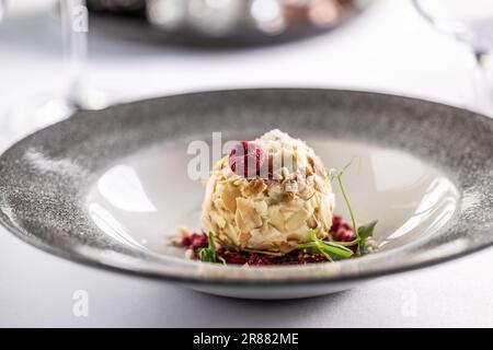 Crème au chocolat blanc savoureuse aux amandes, à la noix de coco et aux framboises. Banque D'Images