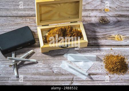 Boîte en bois avec tabac à rouler, cigarettes en rouleau, papiers à cigarettes et filtres Banque D'Images