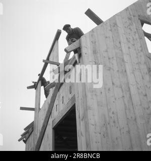 Réel 20-3-1947: Honningsvåg'entre les casernes et les montagnes le long de la mer...' Lorsque les « départements de construction » allemands ont quitté Honningsvåg, seule la minuscule église en bois est restée et a témoigné que Honningsvåg était une petite communauté prospère, le plus grand village de pêcheurs de West Finnmark. Comment se fait-il dans Honningsvåg aujourd'hui, près de trois ans après que les Allemands ont commencé leurs ravages dans Finnmark? Comment va-t-il réellement avec la restauration controversée dans le Nord? "Nous avons besoin d'un château, nous voulons seulement une maison..." Dans le Finnmark, il est appelé 'permanenthus'. Le dessin de la maison a été réalisé par Banque D'Images