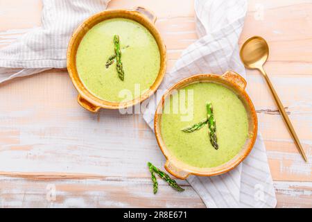 Soupe aux asperges crème sur fond de bois Banque D'Images