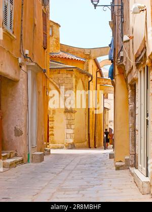 L'étroite rue de ville haute (ville haute) avec vue sur le mur de l'église Sainte-Marie-majeure avec les contreforts volants, Bonifacio, Corse, Fran Banque D'Images