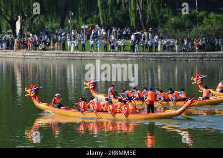 Pékin, Chine. 22nd juin 2023. Les gens regardent une course en bateau-dragon au parc Longtan à Pékin, capitale de la Chine, 22 juin 2023. Une série d'activités, y compris des courses de bateaux, des spectacles, des jeux interactifs ont eu lieu pendant le festival de bateau-dragon ici. Credit: JU Huanzong/Xinhua/Alamy Live News Banque D'Images