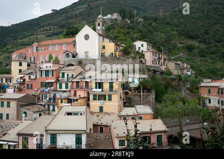 Vernazza Italie - 25 avril 2011; église sur la colline et les toits dans des logements de haute densité dans le village de pêcheurs italien historique de flanc de colline Banque D'Images