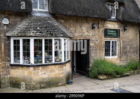 Maisons en pierre historiques avec toits de chaume en détail, boutique de cadeaux et boutique de souvenirs à l'intérieur sur la Highstreet de Broadway, Cotswolds, Worcestershire Banque D'Images