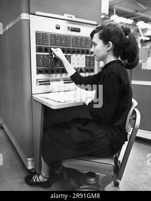 Marietta, Géorgie : c. 1953 Une femme dans un bureau utilisant une machine de traitement de données à tambour magnétique IBM 650. Banque D'Images