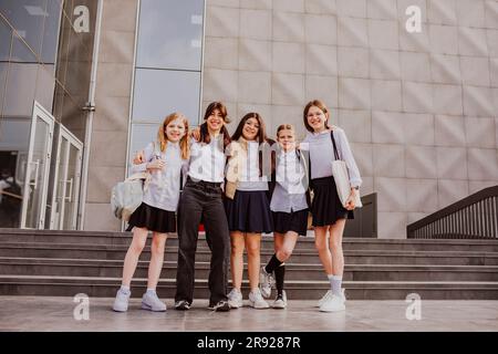 Les écolières portent des uniformes devant le bâtiment de l'école Banque D'Images