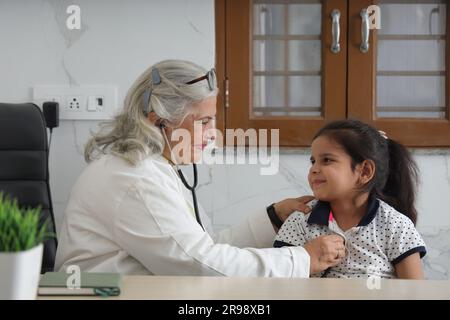 médecin de visite de famille heureuse pour consultation personnelle avec leur fille, fille à l'hôpital, check up, cabine, bureau, conscient de la santé, attention. Banque D'Images