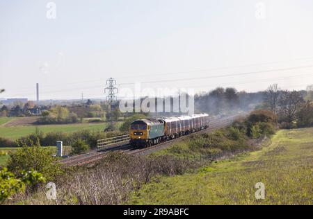GB Railfreight classe 47 locomotive 47749 passant Brogborough sur la ligne Marston vale transportant un EMR classe 360 pour entretien Banque D'Images