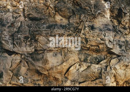 La surface de la falaise en pierre est un arrière-plan et une texture naturelles rugueux Banque D'Images
