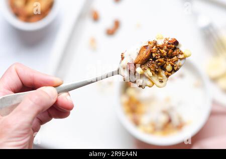 Granola avec noix et banane séchée sur une cuillère. Mise au point sélective. Banque D'Images
