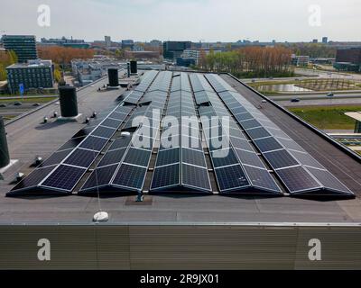 Cette vidéo de drone montre un toit de bureau avec de nombreux panneaux solaires pour l'énergie renouvelable verte. Banque D'Images