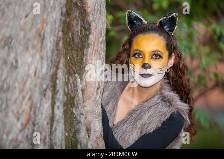 Belle jeune femme portant un costume de loup. Une vraie famille s'amusant en utilisant les costumes du petit conte de cagoule rouge à Halloween. Banque D'Images