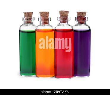 Flacons en verre avec différentes couleurs alimentaires sur fond blanc Banque D'Images