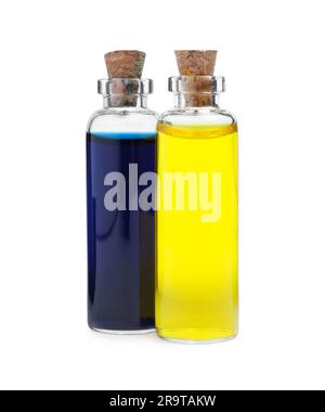 Flacons en verre avec différentes couleurs alimentaires sur fond blanc Banque D'Images