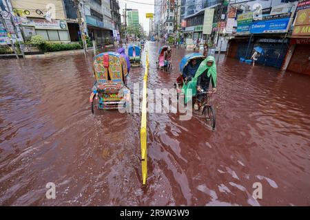 Dhaka, Bangladesh. 29th juin 2023. Les gens se sont emparés d'une route qui a tourné rouge après que le sang des animaux sacrifiés sur Eid Al Adha mélangé avec de l'eau provenant de fortes pluies à Dhaka, au Bangladesh, au 29 juin 2023. (Credit image: © Suvra Kanti Das/ZUMA Press Wire) USAGE ÉDITORIAL SEULEMENT! Non destiné À un usage commercial ! Banque D'Images