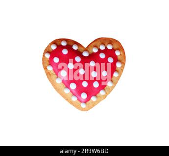 Biscuit en forme de coeur givrant royal à motifs en pointillés sur fond blanc Banque D'Images