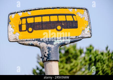 Arrêt de bus jaune signe avec un regard dans les couleurs jaune Banque D'Images