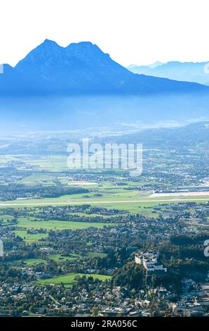 Bassin de Salzbourg vu de la montagne de Gaisberg. Ville de Salzbourg en Autriche avec la forteresse de Hohensalzburg, derrière l'aéroport et les Alpes de Chiemgau. Banque D'Images