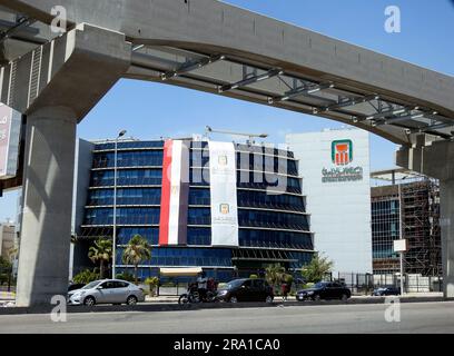 Le Caire, Egypte, 29 juin 2023: Le Caire monorail colonnes et chemin de fer la banque nationale d'Egypte Al Ahly banque égyptienne avec la banque et les drapeaux égyptiens celebb Banque D'Images