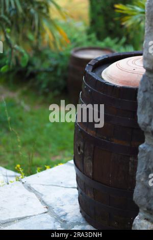 Gros plan d'une cave à vin dans le jardin de la cave de vinification. Baril de vin à l'extérieur de la cave à vin dans le jardin d'un vignoble pittoresque. Image Vetrical, espace de copie Banque D'Images