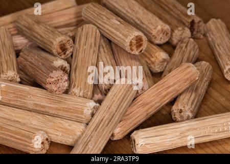 pile de chevilles en chêne sur fond de cèdre, chevilles utilisées pour joindre deux morceaux de bois, joint, menuiserie Banque D'Images