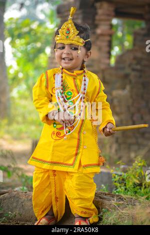 TIKAMGARH, MADHYA PRADESH, INDE - 27 AVRIL 2022 : un mignon garçon indien habillé dans l'avatar du Seigneur Krishna. Banque D'Images