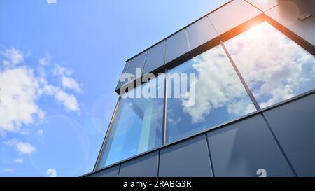 Façade en graphite et grandes fenêtres sur un fragment d'immeuble de bureaux contre un ciel bleu. Façade moderne en aluminium avec fenêtres. Banque D'Images