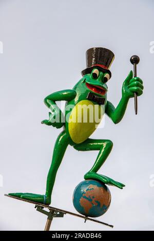 grande grenouille verte en plastique portant un chapeau haut de gamme et tenant une matraque au musée des grenouilles mortes à split, croatie. Banque D'Images