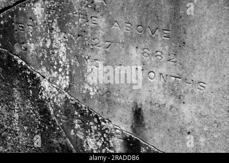 Détail d'une pierre tombale fissurée et âgée de l'époque victorienne pour un enfant décédé dans le cimetière de Bolton Street dans le centre de Wellington, en Nouvelle-Zélande Banque D'Images