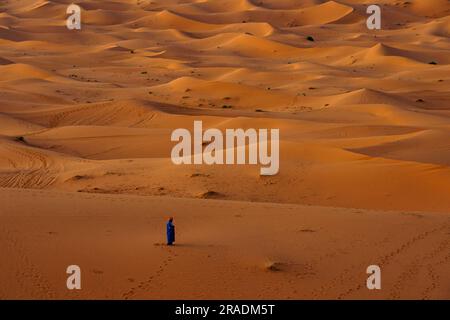 Afrique du Nord. Maroc. Merzouga. Un homme musulman prie dans les dunes de sable du désert du Sahara Banque D'Images