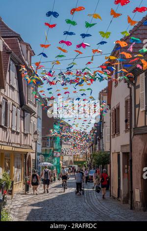 Barr, France - 06 24 2023 : ville de Barr. Vue sur une décoration aérienne de papillons colorés avec des maisons alsaciennes typiques et un fond bleu ciel Banque D'Images