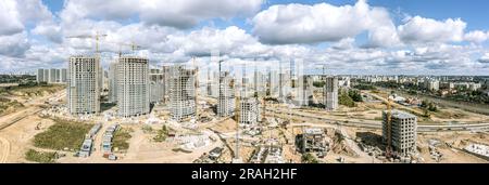 grand chantier de construction avec immeubles d'appartements en construction. vue panoramique aérienne par beau temps d'été. Banque D'Images