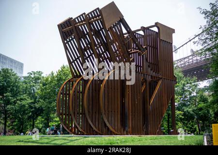 Le « TERRAIN » de Nicholas Galanin est exposé dans le Brooklyn Bridge Park à Brooklyn, à New York, vu samedi, 1 juillet 2023. La sculpture massive de 30 pieds utilise le même acier que celui utilisé pour construire les États-Unis Mur frontalier mexicain qui évoque la « TERRE » évocatrice de la sculpture D'AMOUR de Robert Indiana (© Richard B. Levine) Banque D'Images